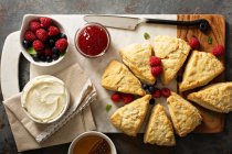 Scones served with cream cheese and berries (top view) — Stock Photo