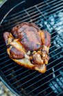 A whole chicken on a barbecue rack — Stock Photo