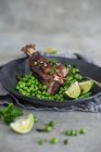 Roasted lamb shanks with peas, mint and lime — Stock Photo