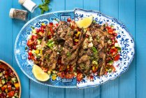 Spicy lamb chops with tomato and pomegranate salsa — Stock Photo