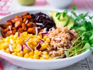 Vegan farro bowl with corn sweet potato black beans and avocado — Stock Photo