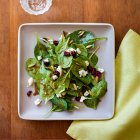 Spinach salad with gorgonzola, pine nuts and pomegranate seeds — Stock Photo