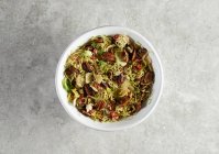 Grated brussels sprouts with maple syrup glazed pecans and pomegranate seeds — Stock Photo