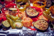 Roasted sweet potatoes and vegetables on foil — Stock Photo