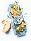 Monkfish skewers with lemon sauce — Stock Photo