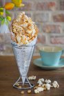 A bubble waffle with popcorn, caramel sauce, peanuts and sea salt — Stock Photo
