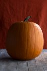 A large halloween pumpkin on a wooden surface — Stock Photo