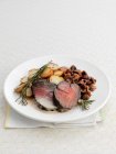 Beef fillets with fried potatoes and rosemary — Stock Photo