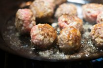 Meatballs being fried in a pan — Stock Photo