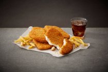 Schnitzel with french fries and cola — Stock Photo