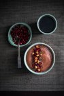 Vegan banana and peanut smoothie bowl with pomegranate seeds, dried apple and flaxseeds — Stock Photo