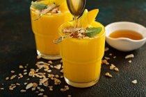 Mango smoothies with honey and coconut — Stock Photo