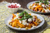 Carrot salad with chickpeas, feta and pomegranate seeds — Stock Photo