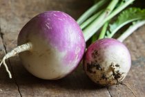 Two turnips on a wooden surface — Stock Photo