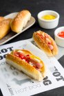 Mini hot dogs in homemade buns with mustard — Stock Photo
