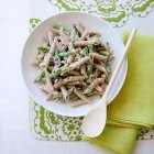 Penne pasta with green beans and bacon — Stock Photo
