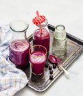 Blabber smoothie with porridge in bottles and glass on tray — Stock Photo