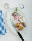 Herring with part peeled potatoes, dill sauce and onion rings — Stock Photo