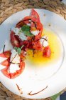 Tomatoes with mozzarella on a plate (top view) — Stock Photo