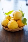 Корзина свежих лимонов с листьями — стоковое фото