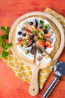 Fruit Pizza made from a toasted Tortilla wrap base, with natural yogurt, fresh fruit toppings, chia seeds and mint to garnish — Stock Photo