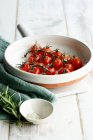 Roasted tomatoes with salt in a baking dish — Stock Photo