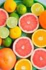 Oranges grapefruit limes lemons on a tray cocktail citrus — Stock Photo