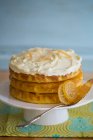 Una torta al limone a tre strati con glassa e limoni canditi — Foto stock