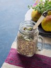 Overnight oatmeal porridge with banana, chia seeds, red quinoa and milk topped with pumpkin seeds — Stock Photo