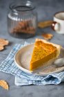 A slice of pumpkin pie on a plate with a spoon — Stock Photo