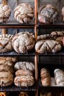Artisan wood-fired bread loaves on shelves — Stock Photo