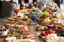 Various party snacks on a wooden table — Stock Photo