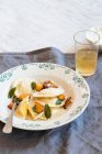 Roasted pumpkin and ricotta ravioli with sage, butter and parmesan cheese — Stock Photo