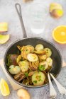 Contour of artichokes small onions and anchovies with citrus peel and parsley — Stock Photo