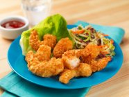Fried prawns in breadcrumbs with salad, close up shot — Stock Photo