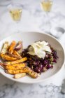 Burger with red cabbage slaw and sweet potato fries — Stock Photo