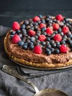 Raw vegan gluten-free chocolate tart with berries — Stock Photo