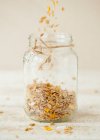 Homemade Granola Being Poured Into a Jar — Stock Photo