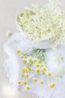 White jasmine flowers in a glass jar on a wooden background — Stock Photo