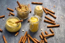 Pretzel sticks with mustards for dipping — Stock Photo