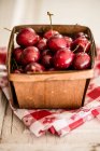 Fresh cherries in a wooden basket — Stock Photo