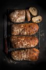 Freshly baked ciabatta bread on cooling rack — Stock Photo