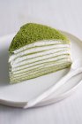 A piece of Mille Crepes cake (pancake cake) with matcha and cream filling — Stock Photo