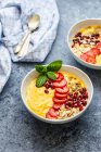 Smoothie-Bowl with mango, passion fruit, strawberries and pomegranate — Stock Photo