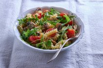 Fusilli with mushrooms, rocket and tomatoes — Stock Photo