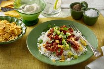 Chilli con carne with avocado, rice and tortilla chips — Stock Photo