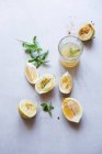 Lemonade with mint in glass and ingredients on table — Stock Photo