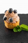 Cupcake with buttercream and blueberries — Stock Photo