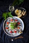 Black caviar with lemon and parsley — Stock Photo