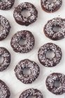 Donuts with chocolate glaze and coconut shreds — Stock Photo